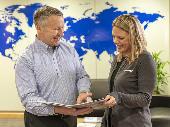 Two people looking at a paper